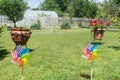 Image of childish colorful pinwheel on the outside. Garden with green grass in a sunny summer day. Rainbow flag LGBT Happy colors Royalty Free Stock Photo