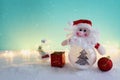 Image of christmas bauble with santa claus in front of pastel blue background Royalty Free Stock Photo