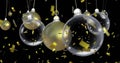 Image of christmas baubles dangling over confetti falling on black background