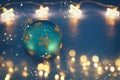 Image of christmas festive tree ball decoration with gold stars in front of blue background. Royalty Free Stock Photo