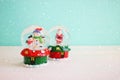 Image of christmas glass ball with snowman in front of pastel blue background Royalty Free Stock Photo
