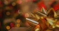 Image of christmas golden ribbon over flickering fairy lights