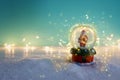 Image of christmas snow glass ball with santa claus in front of blue background Royalty Free Stock Photo