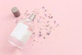 Image of clean elegant perfume bottle over pastel pink background