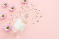 Image of clean elegant perfume bottle over pink pastel background