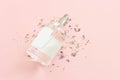 Image of clean elegant perfume bottle over pink pastel background