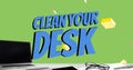 Image of clean your desk text over laptop and office items over green background Royalty Free Stock Photo