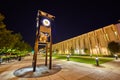 Clock sculpture downtown night in city on walking area