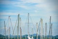 Image close up of boat pole in Marina with docked yachts and moored boats in calm blue sky