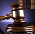 Image of close up of judge slamming gavel on purple background