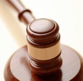 Image of close up of judge slamming gavel on white background