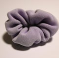 Image of close up of lilac coloured scrunchie on white background