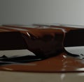 Image of close up of melting chocolate bar on grey background Royalty Free Stock Photo