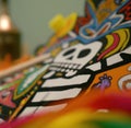 Image of close up of mexican decorated hand made vibrant coloured figurine with skull