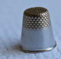 Image of close up of silver thimble on blue fabric background Royalty Free Stock Photo