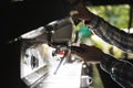 Image closeup of caucasian barista man making coffee while working in cafe or coffeehouse outdoor Royalty Free Stock Photo