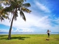 Family outin and coconut tree on the Tanjung Aru Beach, Kota Kinabalu with the beautiful blue sky above on sunny day. Royalty Free Stock Photo