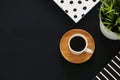 image of coffee cup and notebook over black background. Top view. Royalty Free Stock Photo