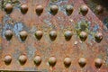 Colorful background asset rusting metal rivets with flaking yellow bits and blue iron patches