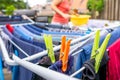 Image of colorful clothespegs on clothline with laundry and blurry woman in the background Royalty Free Stock Photo