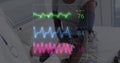 Image of colourful cardiographs over happy diverse patient and doctor taking pressure