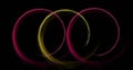 Image of colourful light trails forming circles on black background Royalty Free Stock Photo