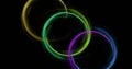 Image of colourful light trails forming circles on black background Royalty Free Stock Photo