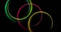 Image of colourful light trails forming circles on black background Royalty Free Stock Photo