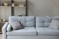 Image of comfortable soft grey sofa with pastel pillows.