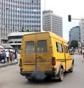 Image of a bus emitting smoke in a city Royalty Free Stock Photo