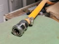 Image of compressor coupler with yellow hose.