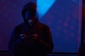 Computer hacker with mobile phone Royalty Free Stock Photo