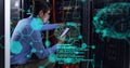 Image of computer language, brains over asian man checking data server using technology Royalty Free Stock Photo