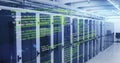 Image of computer language and lens flares over data server racks in server room Royalty Free Stock Photo