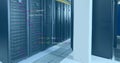 Image of computer language over data server racks Royalty Free Stock Photo