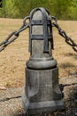 Image of a concrete post with black chains