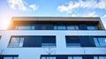 Image of condo on afternoon with sun set. Contemporary white residential building against a blue sky. Royalty Free Stock Photo