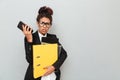 Confused young african business woman holding folders. Royalty Free Stock Photo