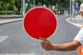 Construction worker holding a Red Stop Sign and directing traffic on the street Royalty Free Stock Photo