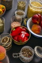 Image of containers and bowls filled with spices, pasta, nectarines and red peppers