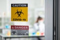 The image of the coronavirus caution signs in the laboratory. the concept of coronavirus, vaccination, laboratory and medical.