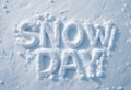 The words \'SNOW DAY\' sculpted in fresh, white snow, symbolizing a break from routine due to winter weather conditions Royalty Free Stock Photo