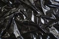 Image of Crumpled sheet of black polythene plastic wrap. Texture for background usage Royalty Free Stock Photo