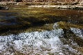 Crystal clear water free flowing from a creek Royalty Free Stock Photo