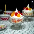 A cup of ambrosia salad with fruits