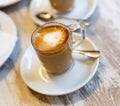 Image of cup of fresh coffee cortado on table