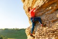 Image of curly-haired climber girl climbing rock Royalty Free Stock Photo