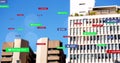 Image of cursors moving over social media icons and text on multi coloured banners on cityscape