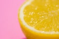 Image of cut half lemon on on a pink background. Minimal concept Royalty Free Stock Photo