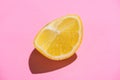 Image of cut half lemon on on a pink background. Minimal concept Royalty Free Stock Photo